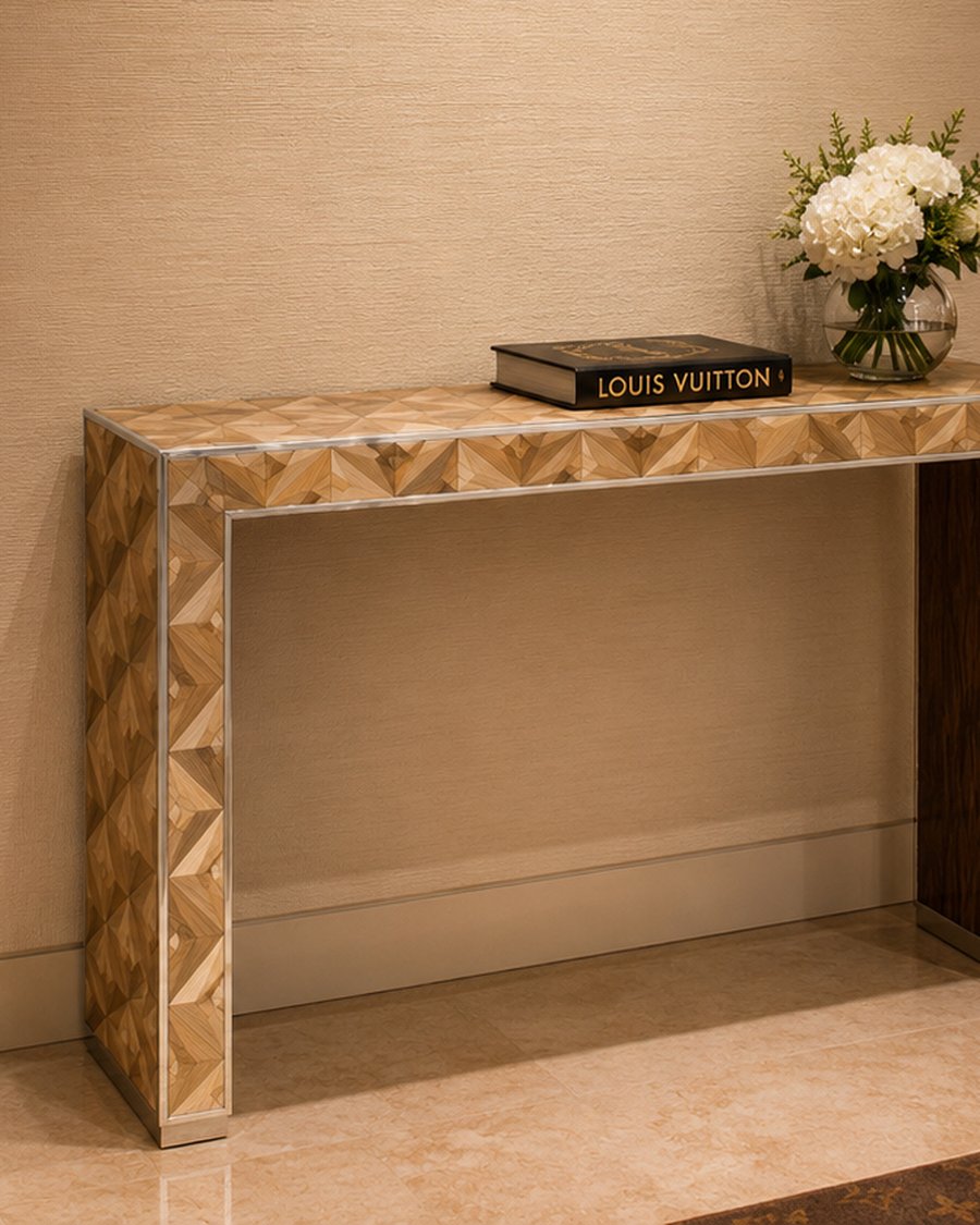 A console table clad in fan-pattern straw marquetry in a Louis Vuitton boutique
